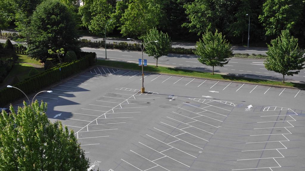 Clean, freshly swept parking lot with crisp parking stripes and no litter